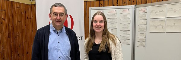 Norbert Krüger und Julia Sell aus dem Fachdienst Personal der Stadt Schleswig hinter einem Messestand der Stadt in der Dannewerkschule